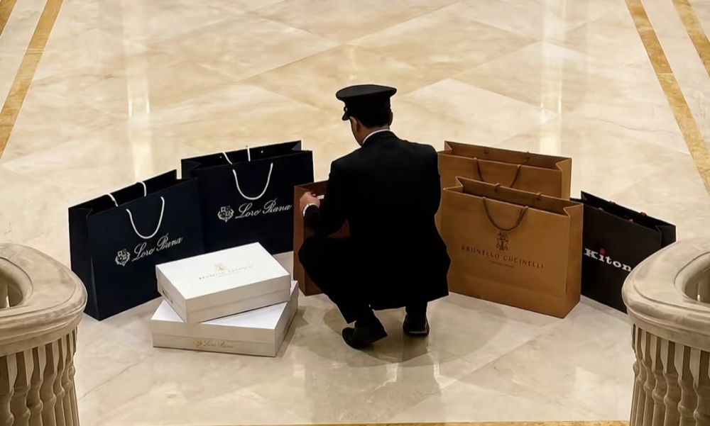 Chauffeur with designer shopping bags and boxes